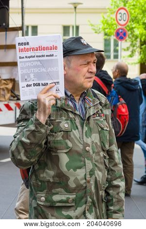 BERLIN - MAY 01 2015: International Labour Day. Distributor of free newspapers.