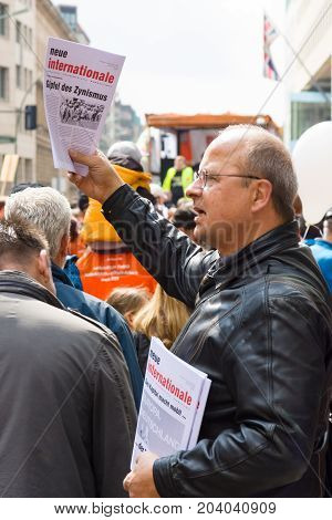 BERLIN - MAY 01 2015: International Labour Day. Distributor of free newspapers.