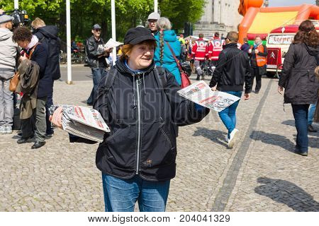 BERLIN - MAY 01 2015: International Labour Day. Distributor of free newspapers.