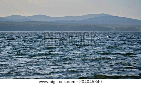 view on the opposite shore of the misty lake, the distance the Ural mountains, South Ural, Uvildy