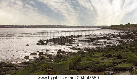 Gravesend Kent to the horizon viewed across River Thames estuary from Tilbury Essex UK