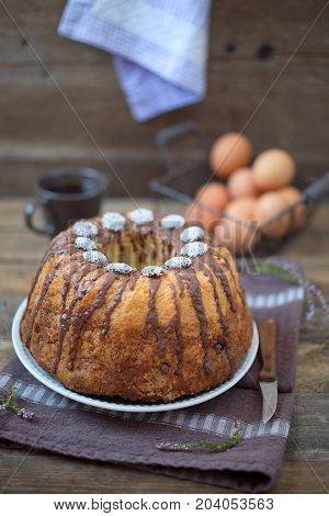 Bundt Cake with Chocolate Fudge Glaze and Chocolate nonpareils with colorful sprinkles on top.