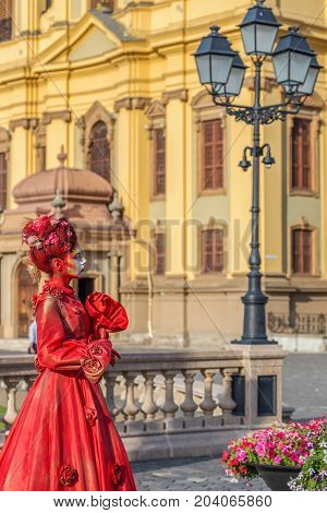 TIMISOARA ROMANIA - SEPTEMBER 8 2017: Portrait of living statue of a woman multicolor dressed and present on the street CheckART Carnival organized by the City Hall Timisoara. Union Square.