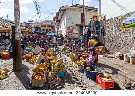 Cusco, Peru - August 08, 2015: People selling and buying fruits at a market in the steets