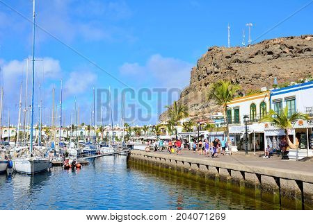 PUERTO DE MOGAN SPAIN - SEPTEMBER 27 2013: Port and promenade of beautiful romantic picturesque village Puerto de Mogan on Gran Canaria on September 27 2013 in Puerto de Mogan Spain.