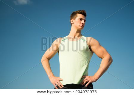 Man Bodybuilder Posing On Blue Sky