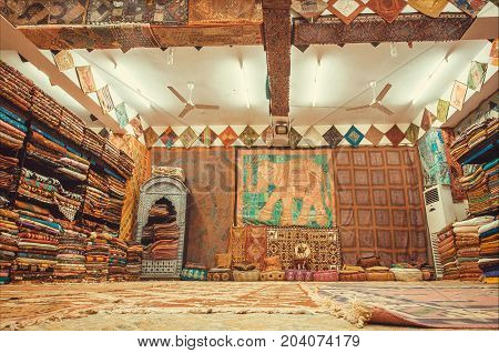 JAIPUR, INDIA - JAN 22, 2015: Store with raditional Indian souvenirs silk shawls carpets and textile of different materials on January 22, 2015. Jaipur with population 6664000 is capital of Rajasthan