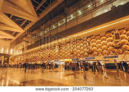 DELHI, INDIA - JAN 21, 2016: Motion blurs from walking passengers inside the International Airport of Delhi on January 21 2016. Indira Gandhi International Airport is the 32th busiest in the world.