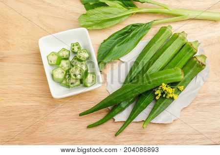 Fresh okra on wooden background,organic vegetables and healthy herb