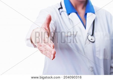 Female doctor giving a hand shake isolated on white.