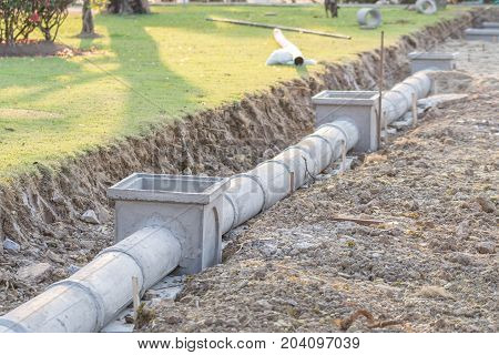 Concrete pipe on construction site soil background