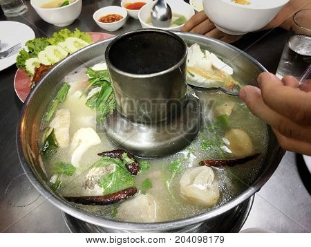 Tom Yam Mixed Sea Food With Mushroom In Hot Pot On Wood Table. Thai Spicy Soup, Famous Thai Dish, Yu