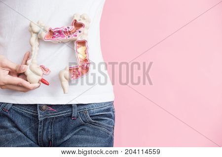 woman with colorectal cancer concept on the pink backgorund