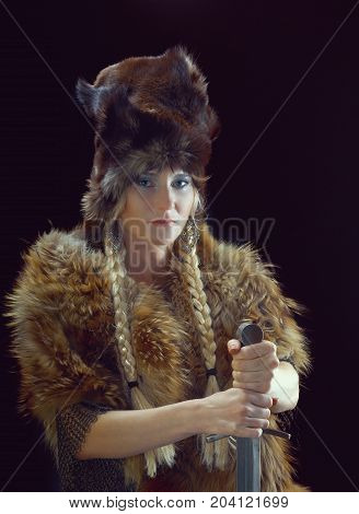 Valkyrie. Viking girl with sword , studio