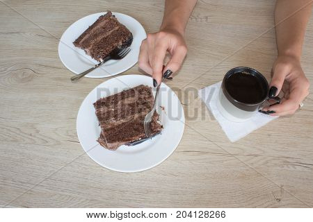 Coffee cup and chocolate cake onon wooden table. Coffee and a piece of cake.