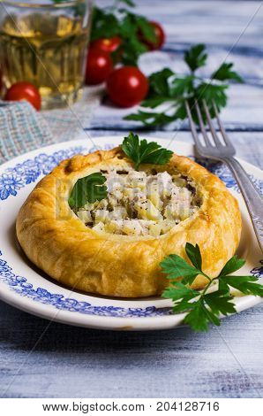Round meat pie with vegetables and spices on a wooden background. Selective focus.