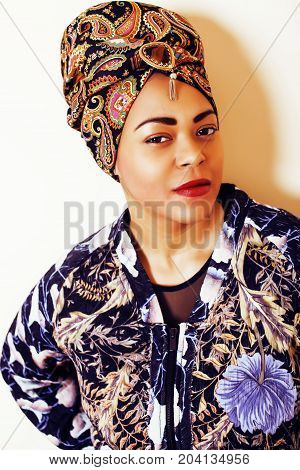 beauty bright african woman with creative make up, shawl on head like cubian closeup smiling, cheerful tan , lifestyle people concept close up