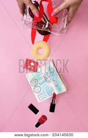 cabin crew items falling out of a clear plastic bag held by female hands