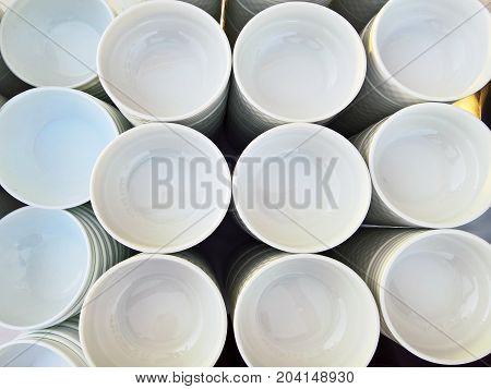 Stack of porcelain plates and bowls in restaurant