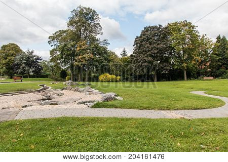 Swadlincote Park Derbyshire water and stone feature. water chanel rock feature with stone and pebble inlays.