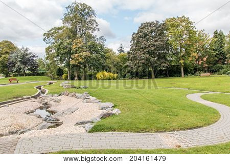 Swadlincote Park Derbyshire water and stone feature. water chanel rock feature with stone and pebble inlays.