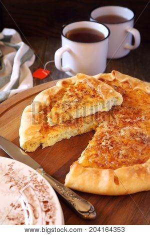 Onion cheese pie on wooden table rustic style