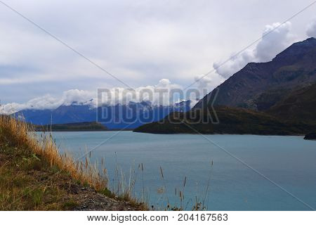 Landscape: Autumn nature lake in the mountains and beautiful clouds
