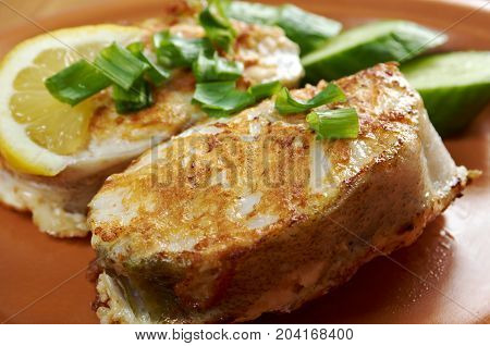 grilled t-bone codfish steak and vegetables close up traditional meal