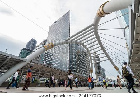 BANGKOK - JUNE 25 2015: Undefined People are walking on the pedestrian bridge which is Bangkok landmark at Chongnonsi SkyBridge at morning for attendance on June 25 2015 in Bangkok Thailand.
