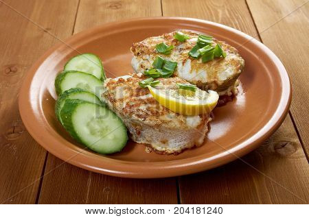 grilled t-bone codfish steak and vegetables close up traditional meal