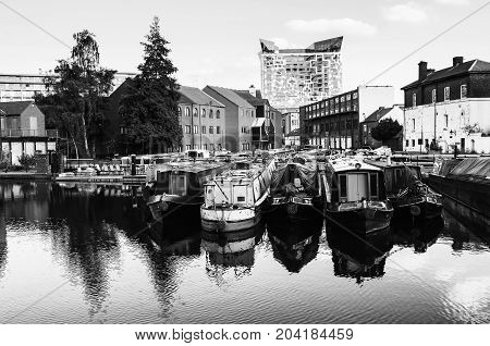 Birmingham UK. Boats moored in the evening at famous Birmingham canal in UK. Black and white