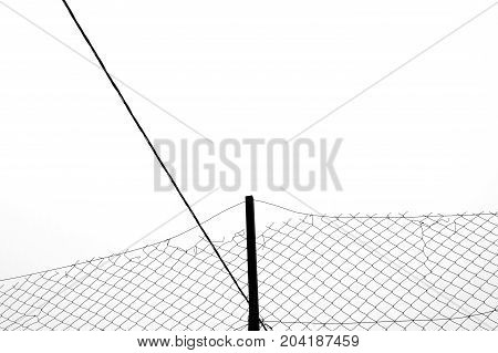 Rusty chain link fence silhouette and cable abstract background. Black and white.