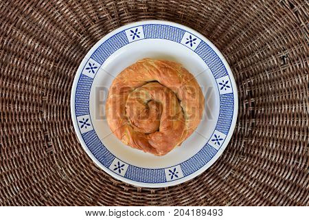 Greek food strifti pita spiral pie filled with feta cheese leek or spinach. Mediterranean cuisine appetizer dish.