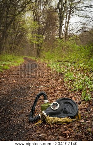 Scary authentic Russian gas mask with breathing hose abandoned in woods