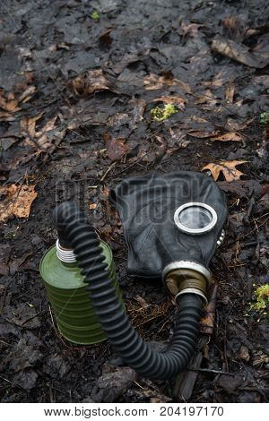 Scary authentic Russian gas mask with breathing hose abandoned in woods