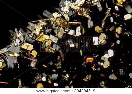 microscopic shot showing colorful microcrystals in polarised light