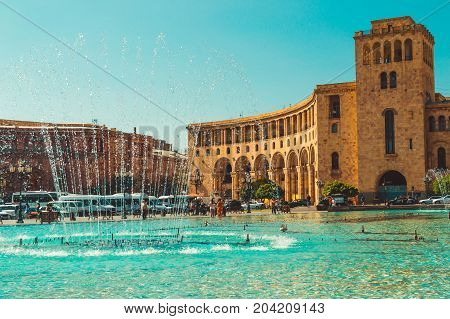 Dancing Fountains and architectural complex on Republic Square. Touristic architecture landmark. Sightseeing in Yerevan. City tour. Government House. Travel and tourism concept. Sunny autumn day.