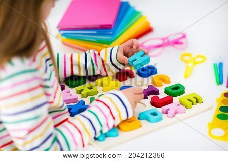 Child Doing Homework For School. Kids Learn And Paint.