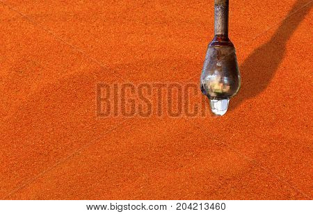 drop of water hanging above the desert. Save our Earth