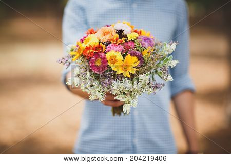 Close-up photo of body parts cute boy. with bright gift, standing in the forest. Lifestyle concept.