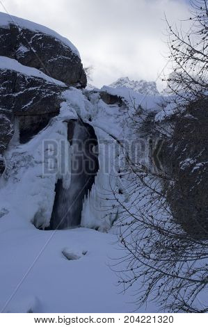 small waterfall in formazza valley during winter