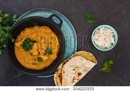 Delicious Indian chicken korma with rice and butter naan, top view