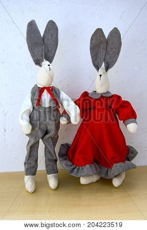 Cute Rabbits, A Couple For A Walk In Front Of A Light Wall, A Girl In A Red Satin Dress And A Cheval