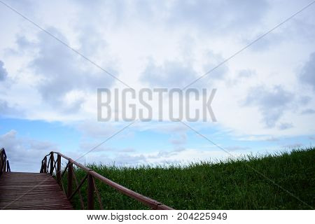 picture took of a bridge ,from the street to the beach