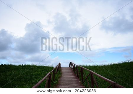 picture took of a bridge ,from the street to the beach