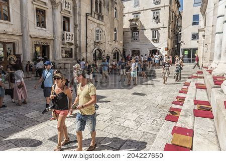 SPLIT, CROATIA - JULY 12, 2017: Tourists on the square Peristil in Diocletian's palace.