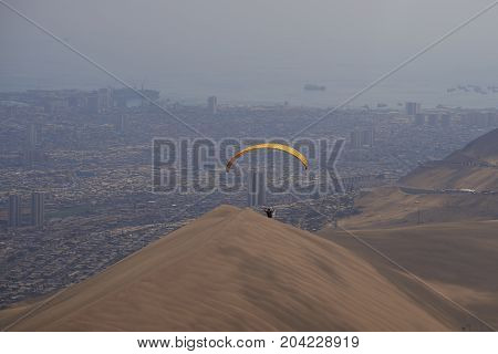 Iquique, Tarapaca Region, Chile - August 20, 2017: Paraglider over the coastal city of Iquique on the northern coast of Chile.