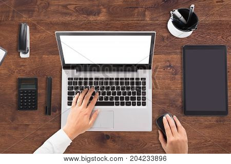 Elevated View Of A Businessperson Using Laptop With Blank White Screen On Desk