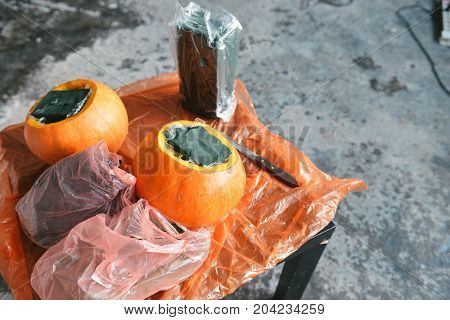 Beautiful autumn floral bouquet in a pumpkin vase. Preparing for Halloween. Table setting for the wedding