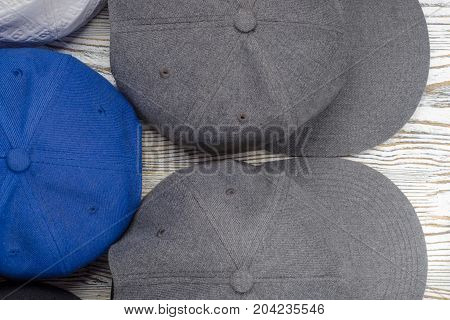 Snapback hats on white wooden background isolation